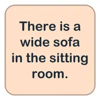 Picture for There is a wide sofa in the sitting room. (Oturma odasında geniş bir kanepe var.)